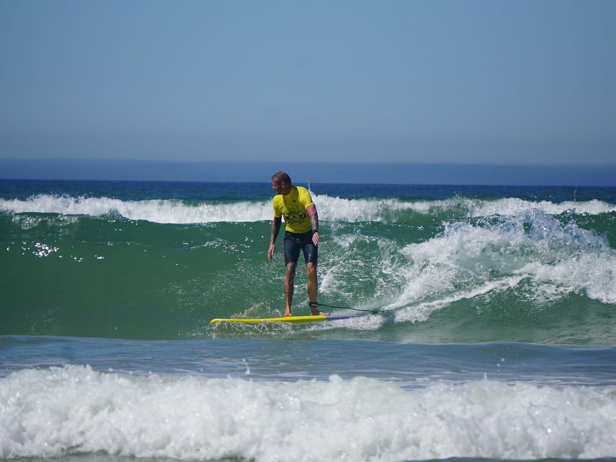 Two surfers with their coach at Praia de Faro