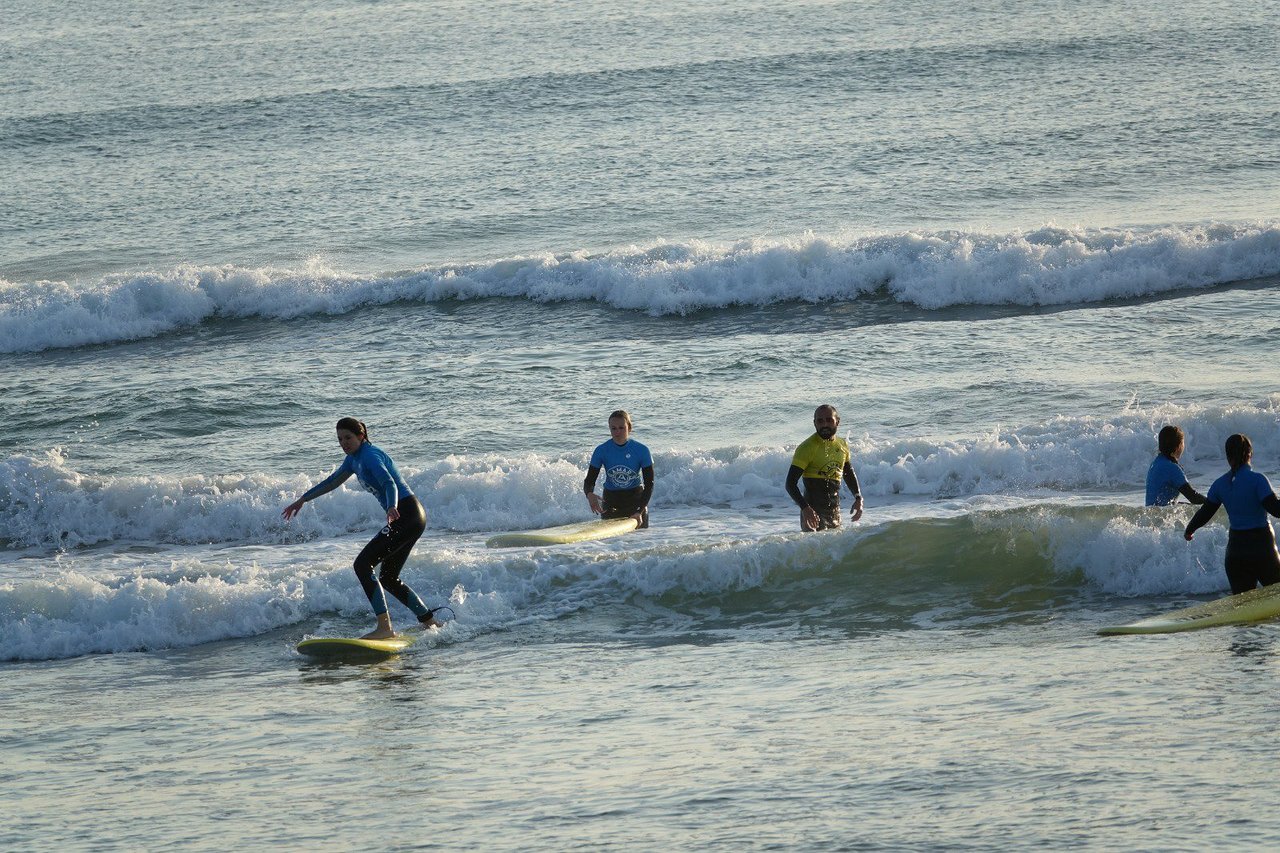 Family surfing together at Praia de Faro