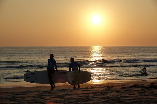 One-on-one surf coaching at sunset on Praia de Faro
